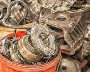 Bucket Of Used And Worn Out Automobile Parts.