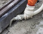 Mortar From Grout Mixer And Delivery System, Grouting Pump Used To Settle The Grout Into The Joints. Grouting Mortar And Tram Track Laying. Selective Focus And Shallow Dof.